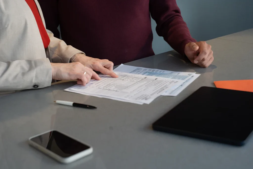 People reviewing paperwork at a table