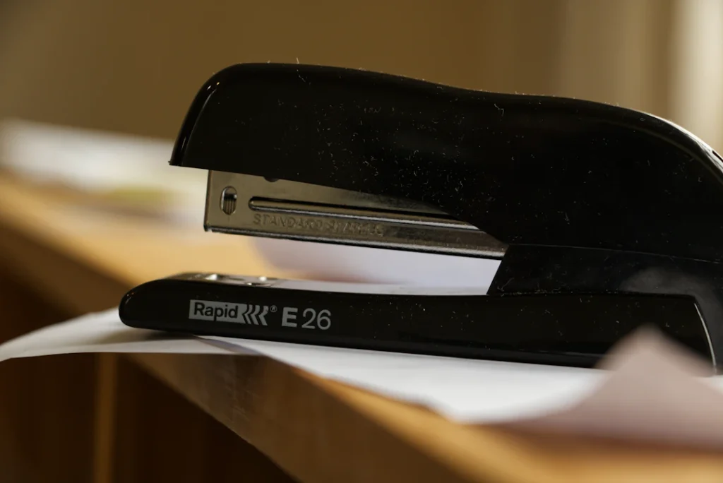 Stapler beside papers on a desk